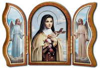 St. Therese of Lisieux wooden tryptypch with St. Therese in the center and angels on the two outer pieces. She is also known as "The Little Flower" and is the Patron Saint of Florists, Missionaries and Gardeners. Item stands approximately 3.75 inches high and 5 inches wide. It is brand new and made in Italy 